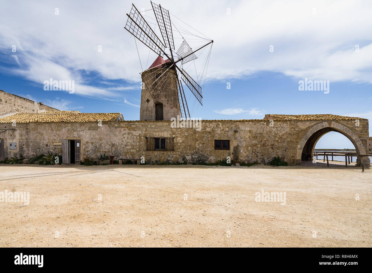 Typical old windmill now housing a salt museum (Museo del Sale) at Trapani salt flats, Sicily, Italy Stock Photo