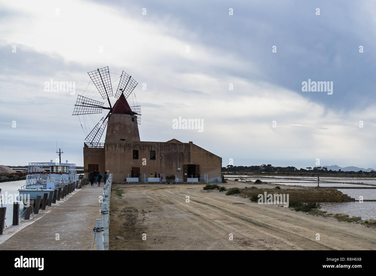 The “Mulino d'Infersa” is an old restored windmill at Stagnone Nature Reserve, now housing a museum about salt and rural life, Marsala, Sicily, Italy Stock Photo