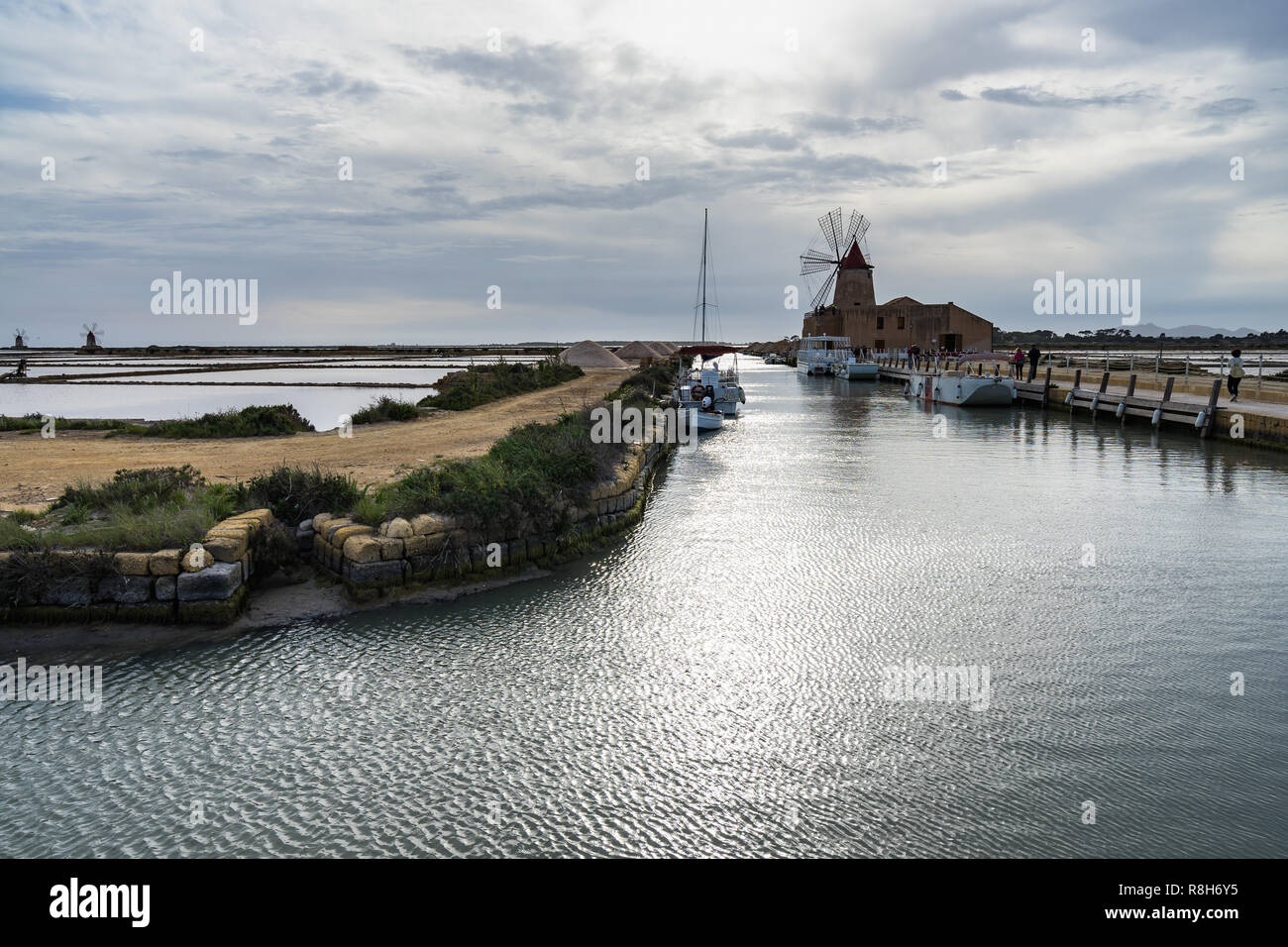 Landscape of salt work and historic old mill now used as Salt Museum at Satagnone Nature reserve between Trapani and Marsala, Sicily, Italy Stock Photo