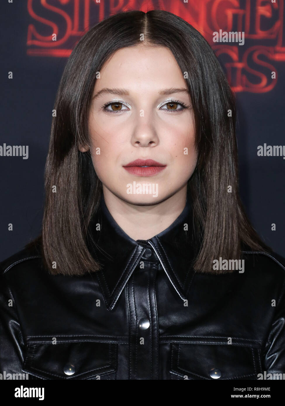 WESTWOOD, LOS ANGELES, CA, USA - OCTOBER 26: Actress Millie Bobby Brown  wearing a Calvin Klein dress arrives at the Los Angeles Premiere Of  Netflix's 'Stranger Things' Season 2 held at the