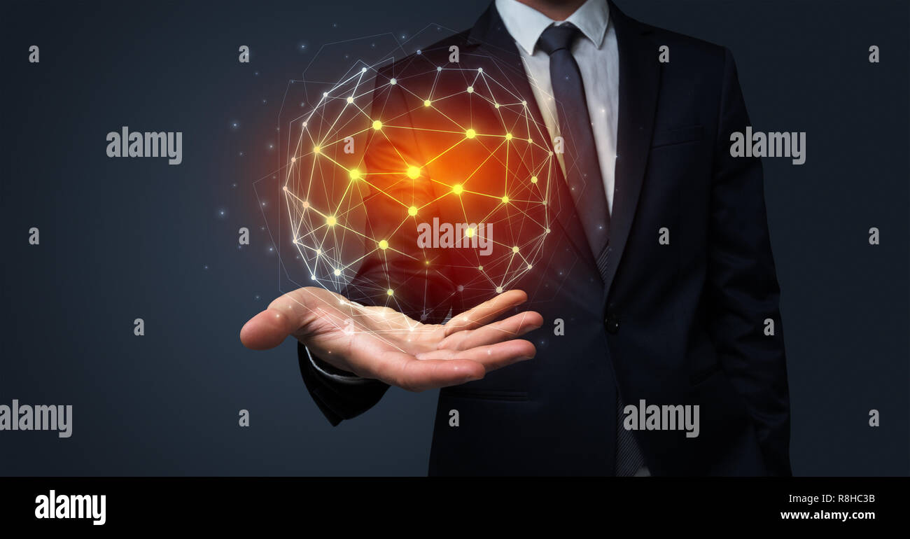 Businessman in suit holding global connection symbol on his hand Stock Photo