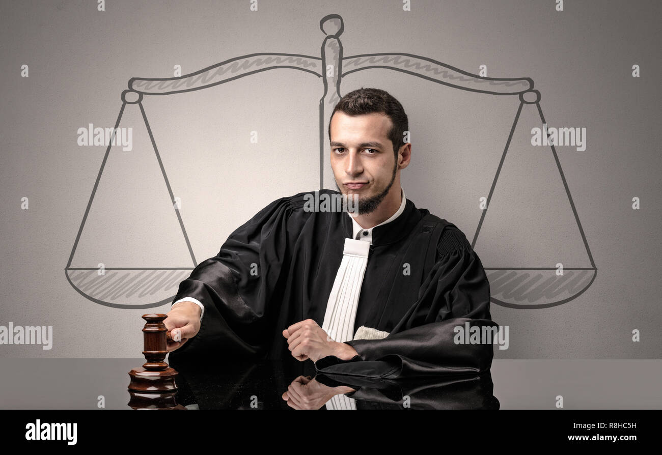 Young handsome judge in black gown making decision Stock Photo
