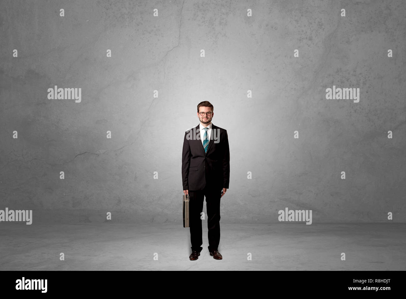 Alone handsome businessman standing in a dark empty room Stock Photo ...