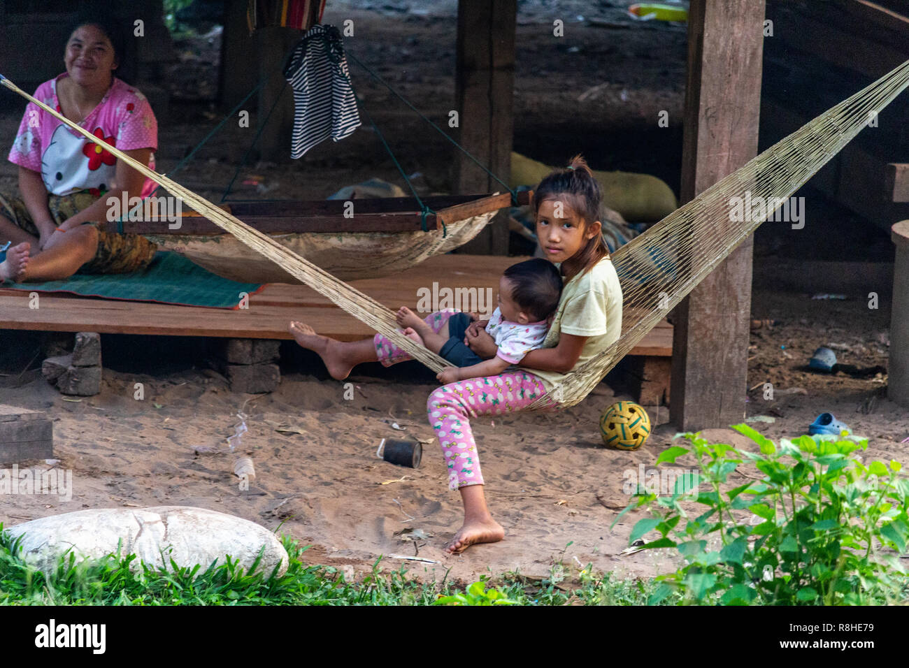Thakhek, Laos April 20, 2018 Children on an hammock with the family enjoying the life in the