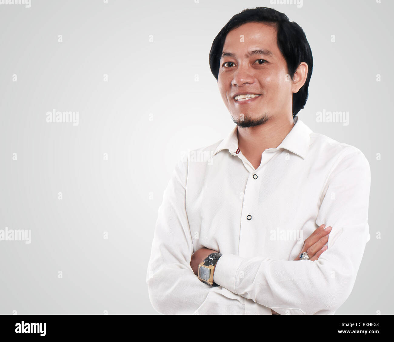 Photo image portrait of a handsome young successful and confident Asian businessman looked very happy and smiling, half body close up portrait with cr Stock Photo