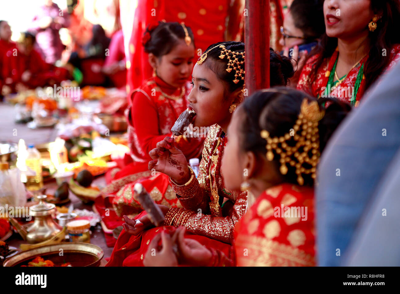 Kathmandu, Nepal, 15th December 2018. Newar girls in bridal dresses are seen performing ritual during the IHI ceremony. IHI also called Bel Bibaha is unique traditional ceremony practiced in Newar communities before puberty. In Newar community girls are married three times in their lives, first is IHI ceremony, which last for two days where girls are married to Lord VISHNU,  Second they are married to the Sun and finally with their real husband. Credit: SOPA Images Limited/Alamy Live News Stock Photo
