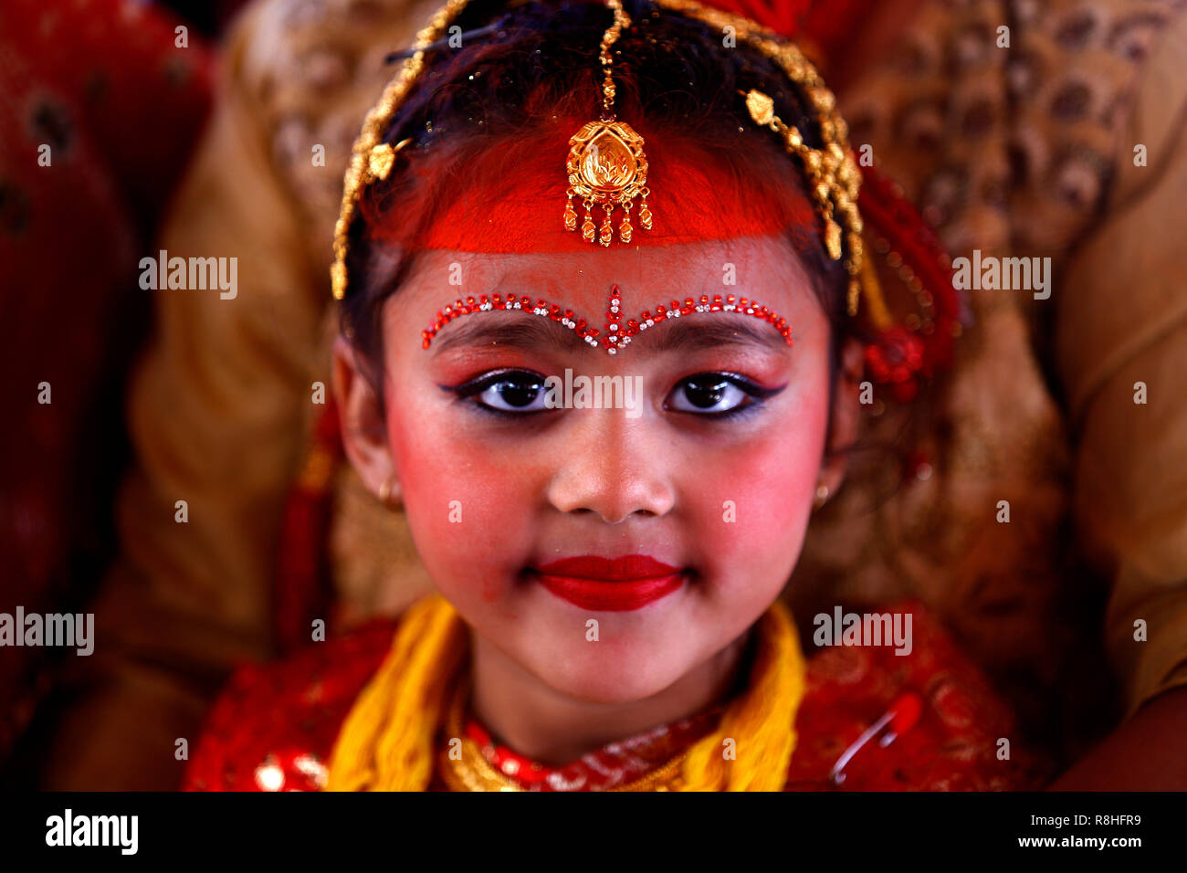Kathmandu, Nepal, 15th December 2018. An adorned Newar girl in bridal dress is seen performing ritual during the IHI ceremony. IHI also called Bel Bibaha is unique traditional ceremony practiced in Newar communities before puberty. In Newar community girls are married three times in their lives, first is IHI ceremony, which last for two days where girls are married to Lord VISHNU,  Second they are married to the Sun and finally with their real husband. Credit: SOPA Images Limited/Alamy Live News Stock Photo