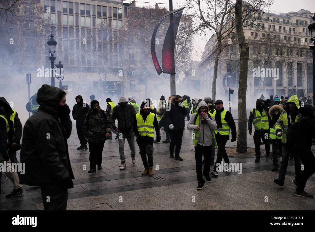 Paris, France. 15th December 2018. Police line with armored water tank and  several protestors. Yellow Vest (Gilet Jaune) protest on the  Champs-Elysees, Paris, December 15, 2018. Credit: Julien Garnier/Alamy Live  News Stock