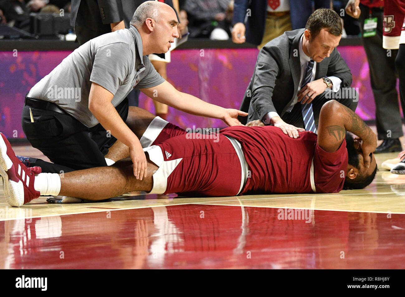 December 12, 2018 - Philadelphia, Pennsylvania, - Massachusetts Minutemen head coach MATT MCCALL and medical staff check on Massachusetts Minutemen center RASHAAN HOLLOWAY (45) after an apparent ankle injury early in December 12, 2018 - Philadelphia, Pennsylvania, - Massachusetts Minutemen head coach MATT MCCALL and medical staff check on Massachusetts Minutemen center RASHAAN HOLLOWAY (45) after an apparent ankle injury early in