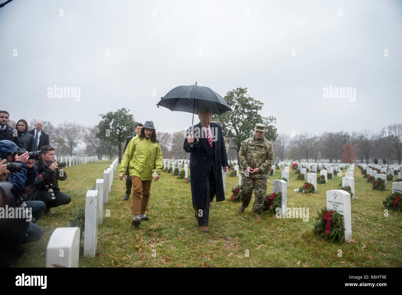 Arlington National Cemetery, Texas, USA. 15th Dec 2018. U.S. President Donald Trump, center, walks through Section 60 Arlington National Cemetery escorted by Karen Durham-Aguilera, left, and U.S. Army Sgt. Maj. Juan Abreu, right, December 15, 2018 in Arlington, Virginia. The president spent 15 minutes looking at the thousands of grave markers that had been decorated with holiday wreaths at the start of Wreaths Across America. Credit: Planetpix/Alamy Live News Stock Photo