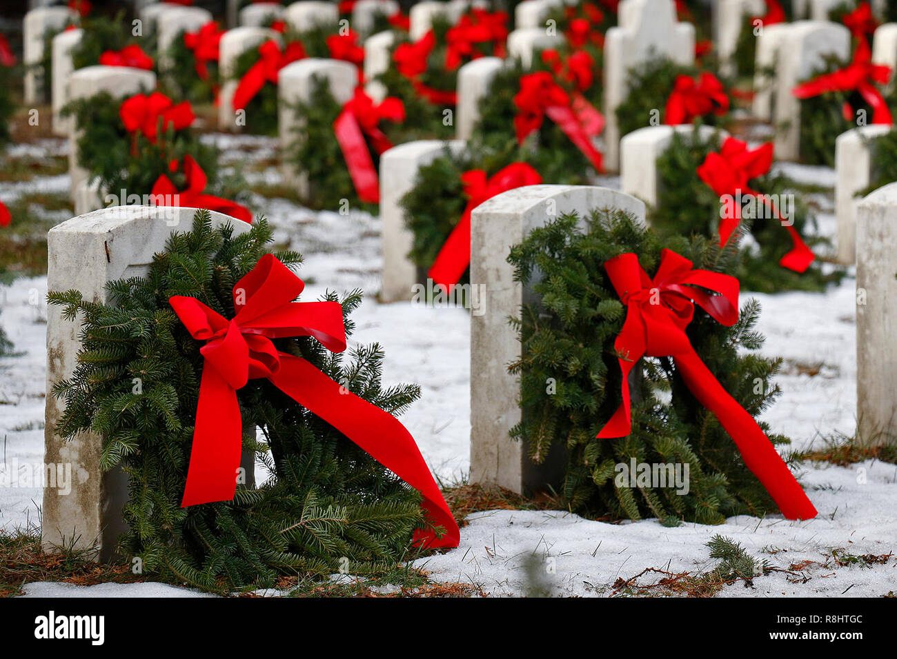 Christmas wreaths decorate the gravesites of service members during the 27th National Wreaths Across America Day at Sackets Harbor Military Cemetery December 15, 2018 in Sackets Harbor, New York. Stock Photo