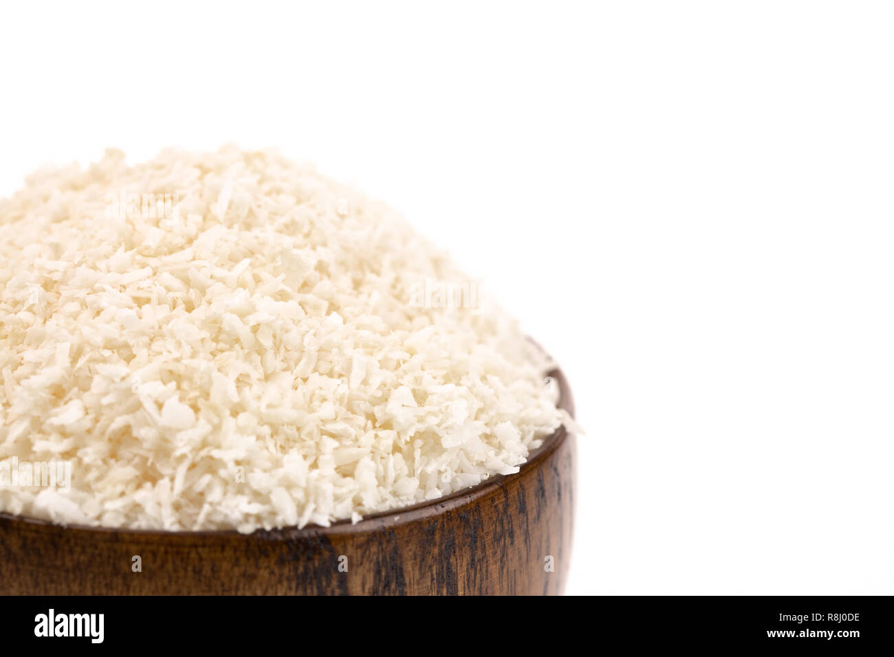 Raw Organic Unsweetened Coconut in a Wooden Bowl Stock Photo