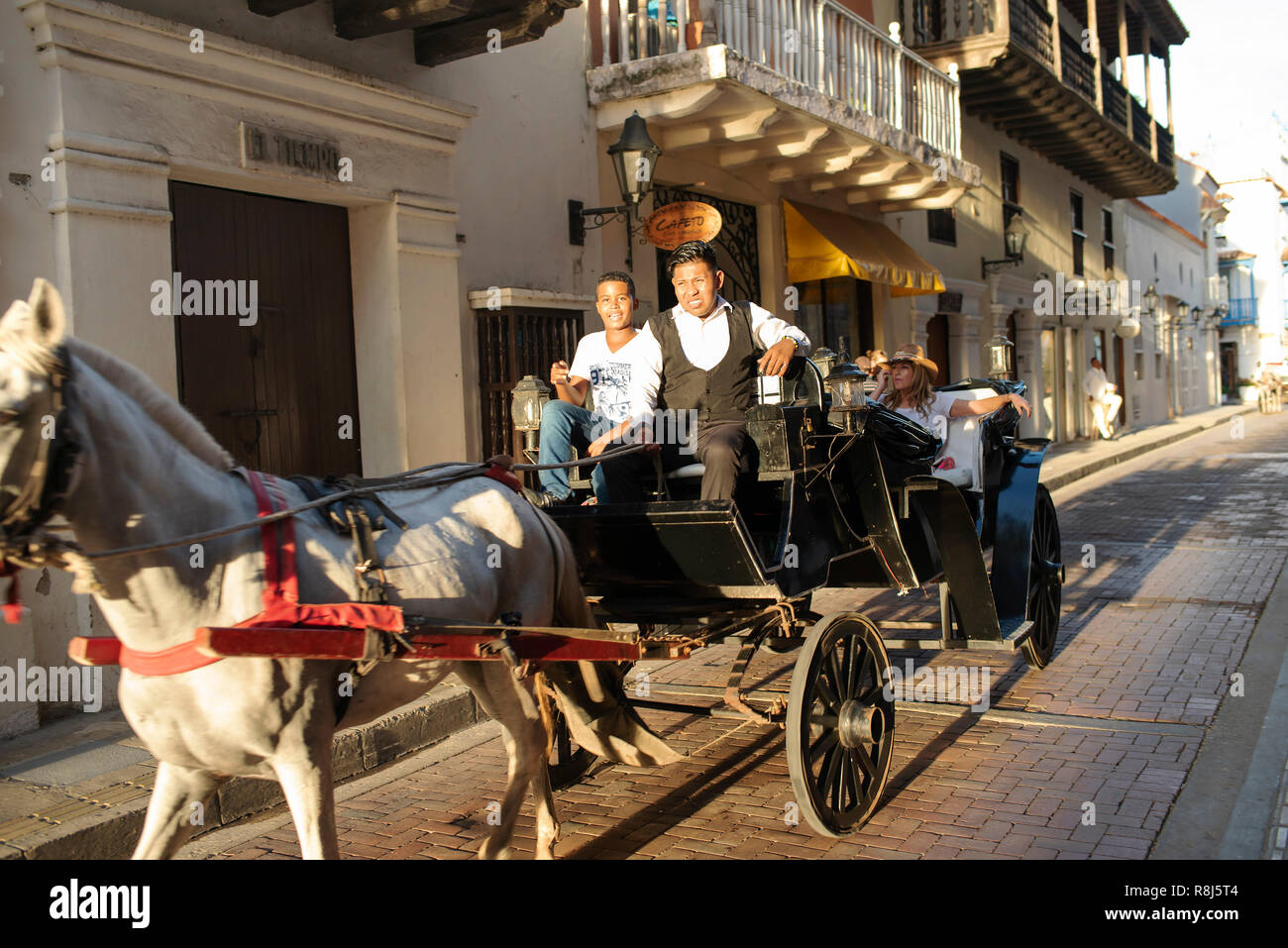 A horse cart with tourists speeding through the old town of Cartagena de Indias, Colombia. Oct 2018 Stock Photo