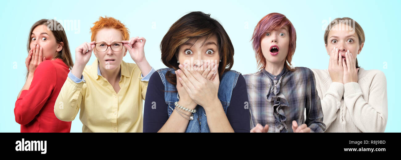 Horizontal portrait of several female closes hands over mouth in shock by what they heard. Stock Photo