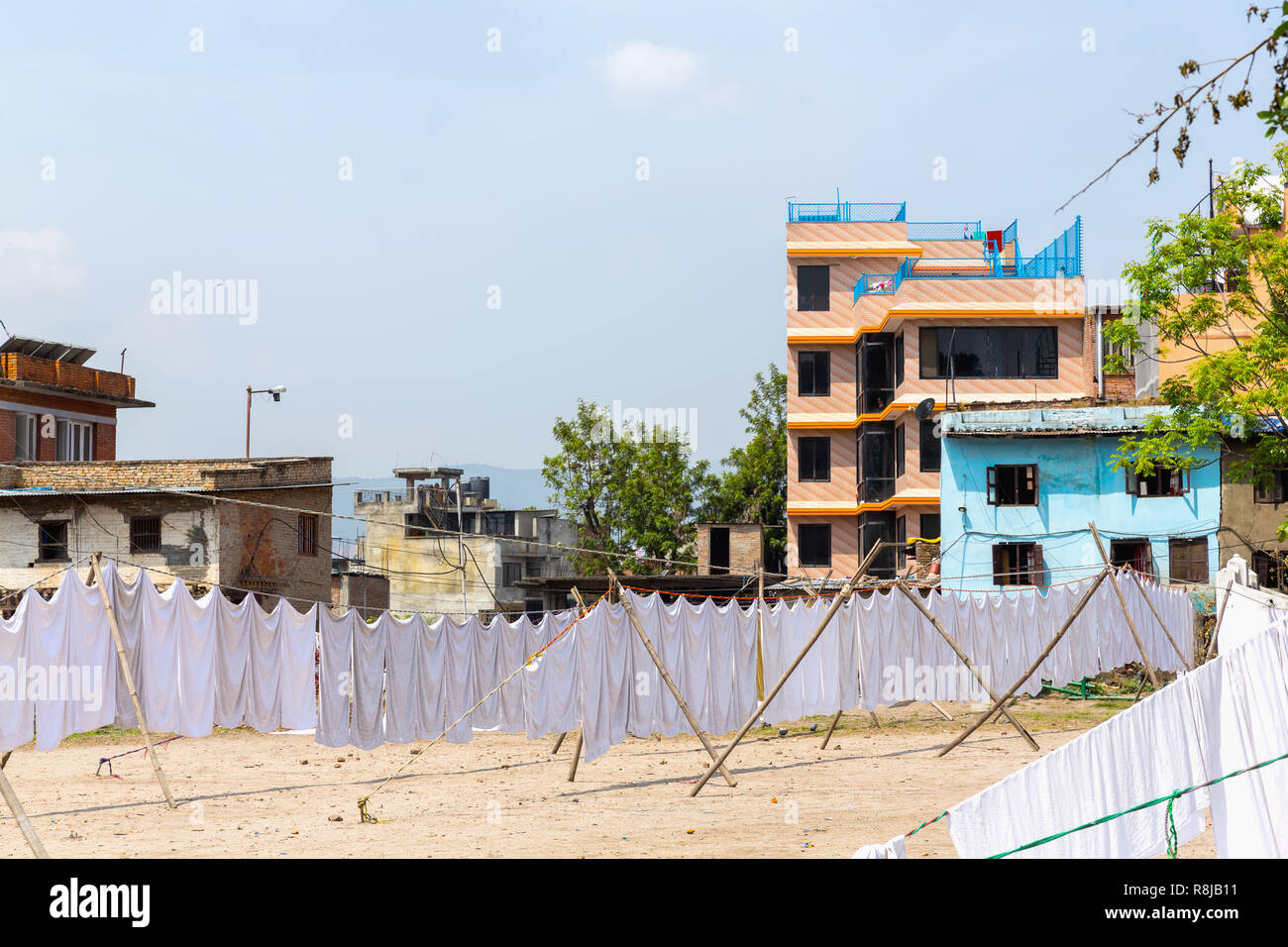 Fresh washed white sheets hanging to dry in Kathmandu, Nepal Stock Photo