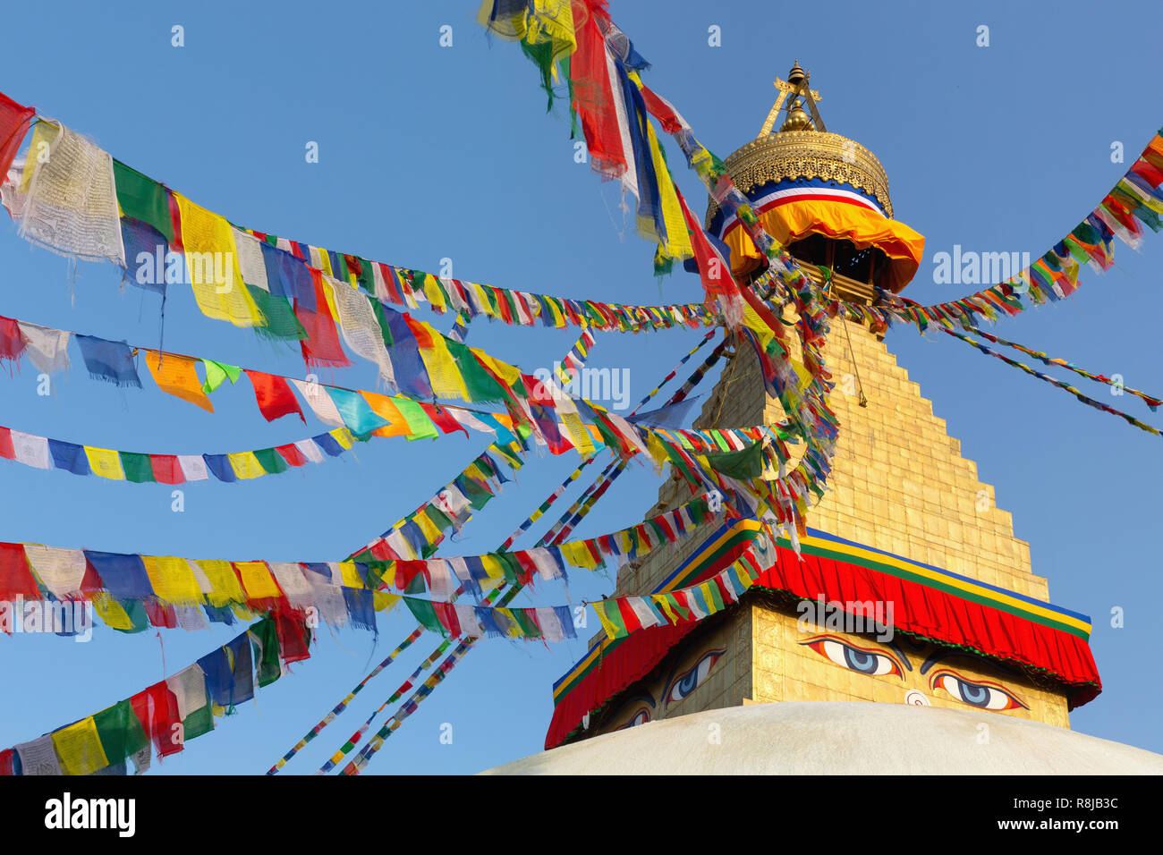 Prayer flags flying at the Boudhanath Stupa in Kathmandu, Nepal Stock Photo