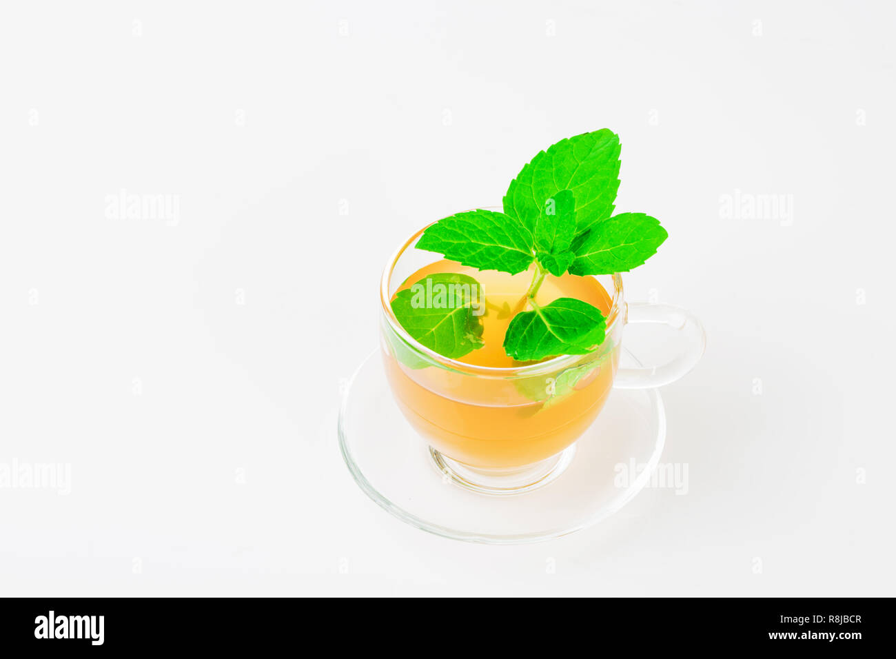 Mint tea. Cup of tea with fresh mint leaves on a white background. Stock Photo