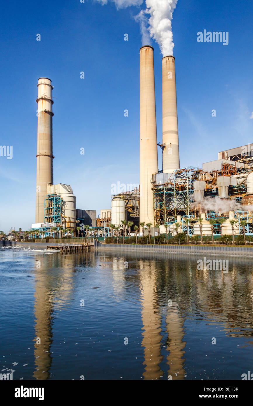 TECO Power plant with tall smoke stacks on a coastal plain. There is a manatee preserve and viewing center surrounding the plant. Stock Photo