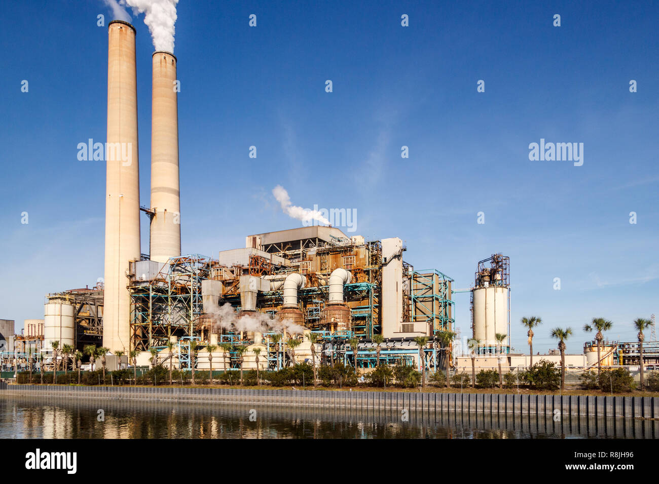 TECO Power plant with tall smoke stacks on a coastal plain. There is a manatee preserve and viewing center surrounding the plant. Stock Photo