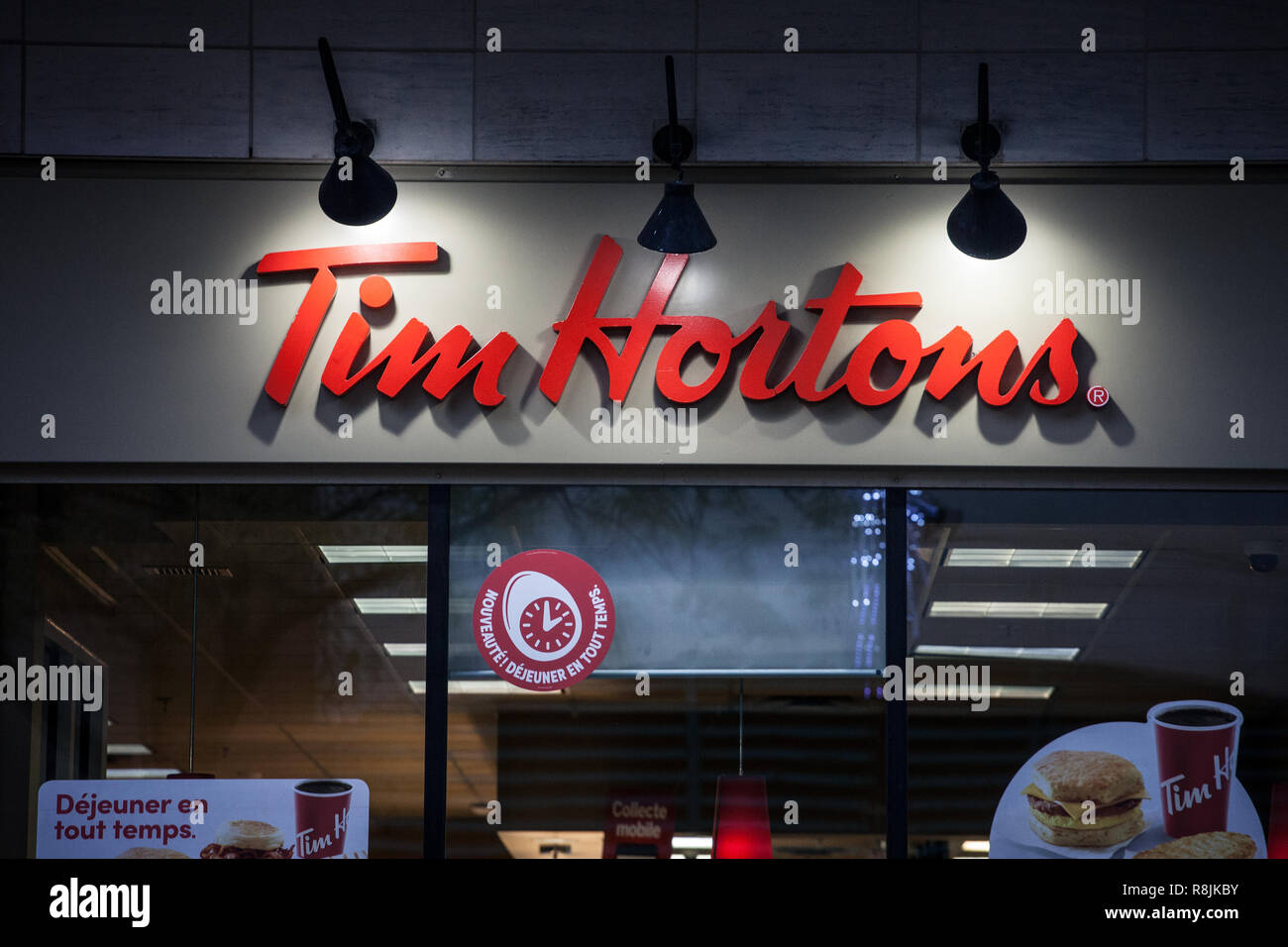 MONTREAL, CANADA - NOVEMBER 5, 2018: Tim Hortons logo in front of one of their restaurants in Montreal, Quebec. Tim Hortons is a cafe and fastfood can Stock Photo