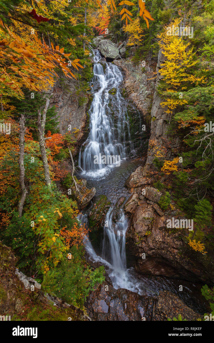 Crystal Cascade is a lovely waterfall located in Pinkham Notch, NH.  Here the Ellis River drops about one hundred feet surrounded by colorful  foliage. Stock Photo