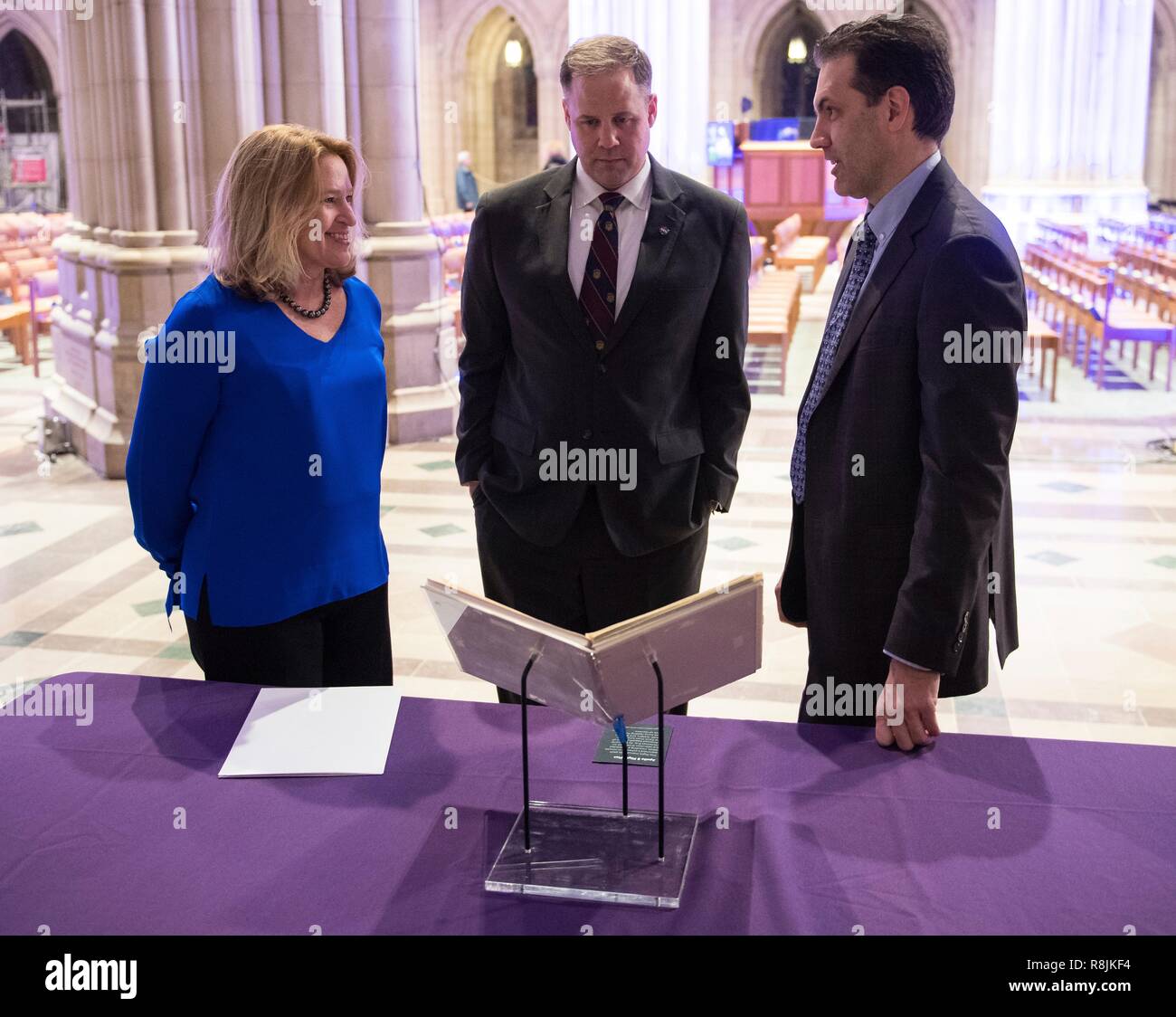 Director of Smithsonian National Air and Space Museum Ellen Stofan, left, NASA Administrator Jim Bridenstine, center, and Andrew Johnston, from the Chicago Adler Planetarium view NASA astronaut Jim Lovells Apollo 8 flight plan on display at the Spirit of Apollo event commemorating the 50th anniversary of Apollo 8 at the National Cathedral December 11, 2018 in Washington, DC. Apollo 8 was the first manned spaceflight to the Moon and back carrying astronauts Frank Borman, Jim Lovell, and William Anders in December of 1968. Stock Photo