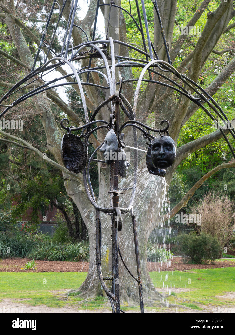 Faces On A Sculpture In The Christchurch Botanical Gardens Stock Photo