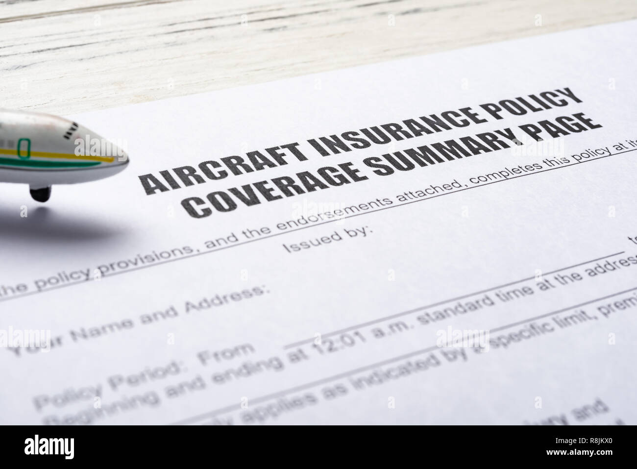 side view aircraft insurance policy coverage form and an airplane model