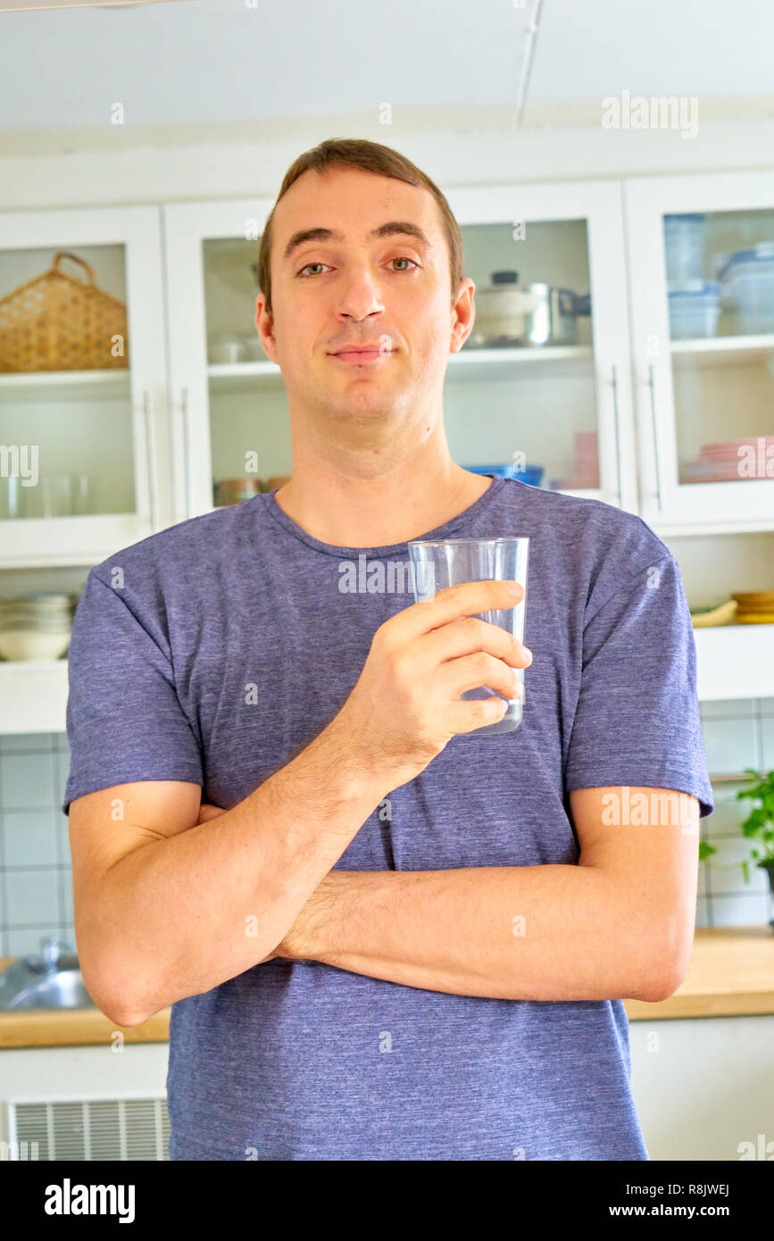 Handsome guy posing - drinking water and sulking Stock Photo
