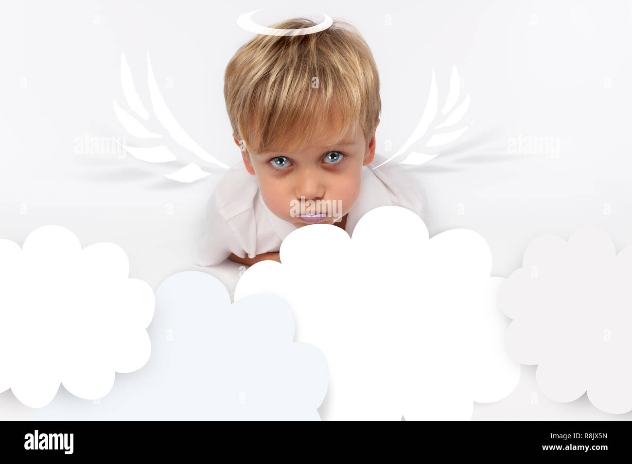Naughty or good child for Christmas card? PF or letter to Santa-Claus for Christmas. Little child boy appearing as an adorable angelic devil Stock Photo