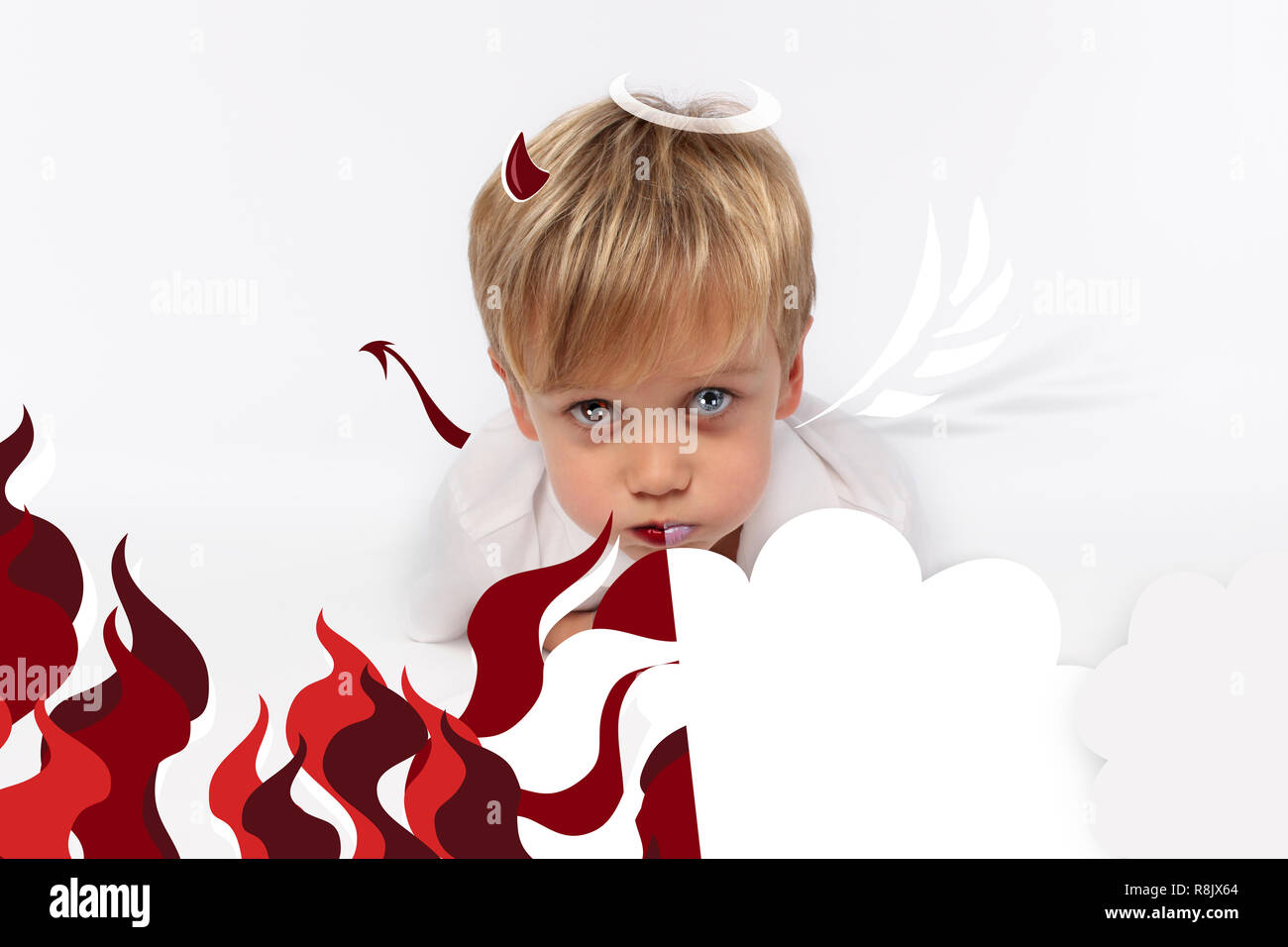 Naughty or good child for Christmas card? PF or letter to Santa-Claus for Christmas. Little child boy appearing as an adorable angelic devil Stock Photo
