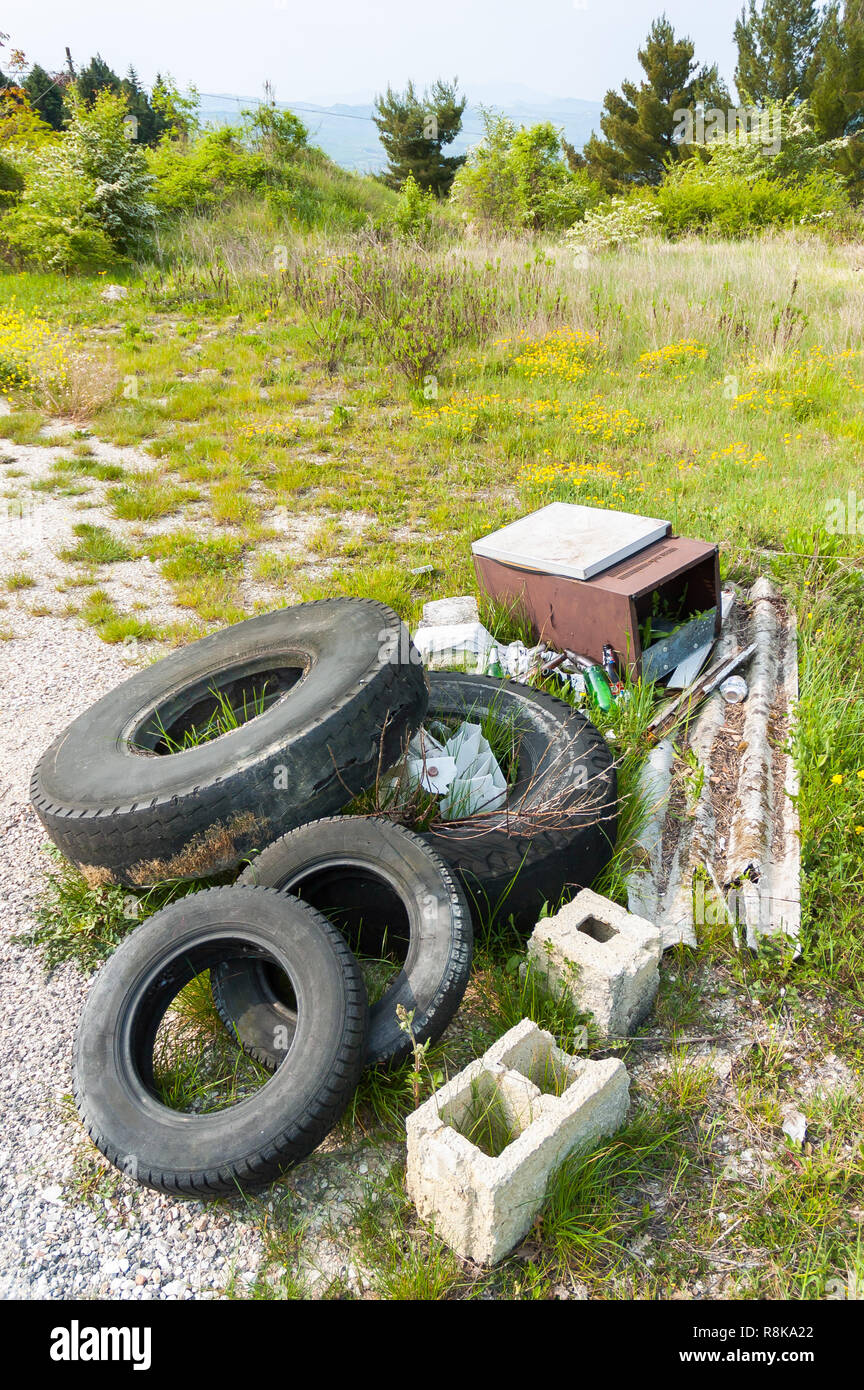 Old tires left in the Nature by disrespectful people, in the Italian countryside Stock Photo
