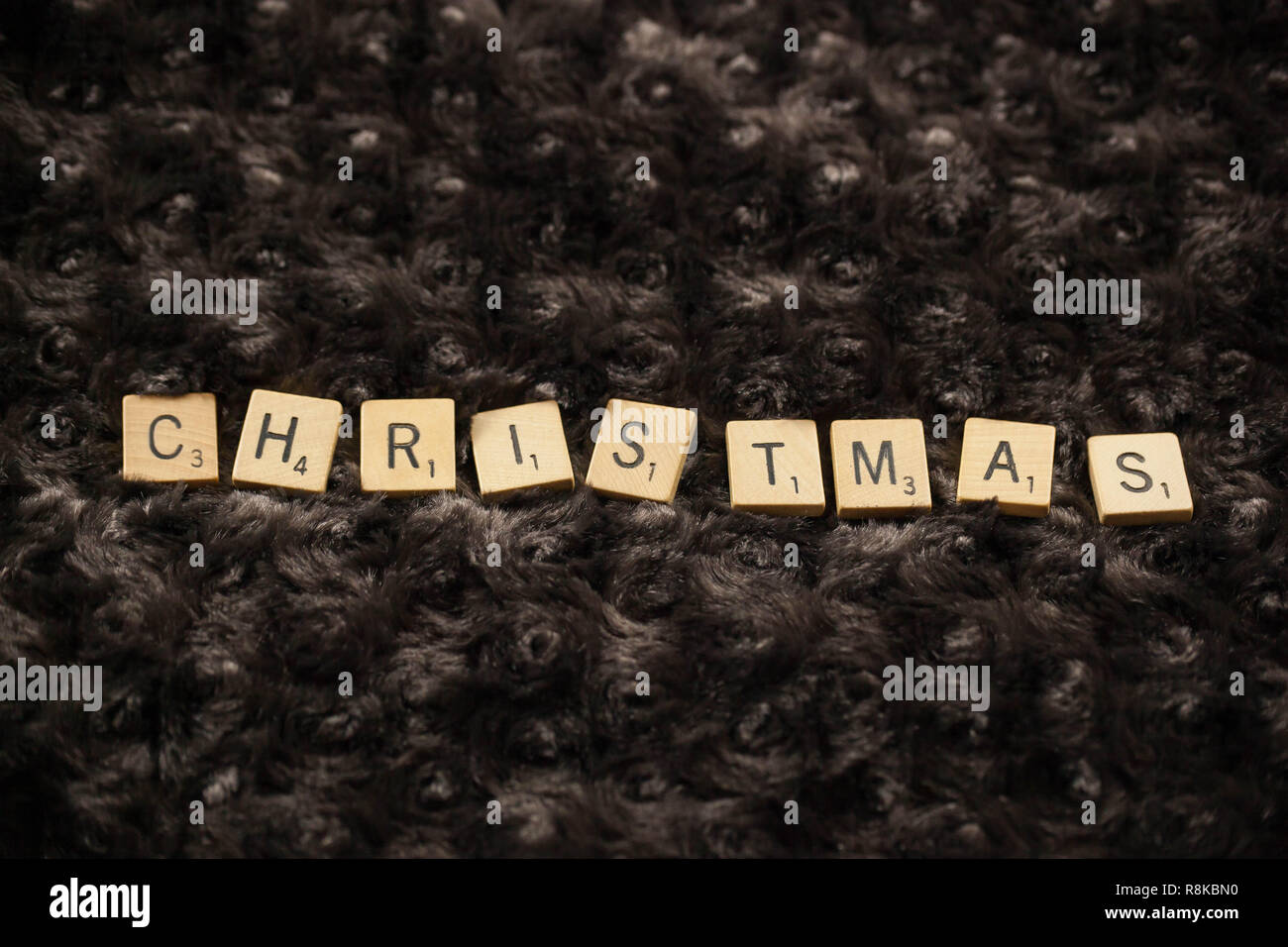 WOODBRIDGE, NEW JERSEY - November 9, 2018: Scrabble tiles spell out the word Christmas on a brown fur background Stock Photo
