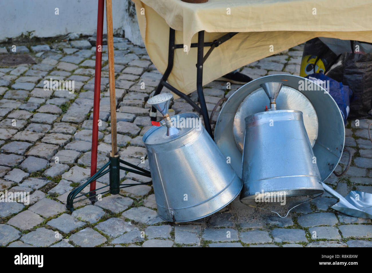 Simple metal bucket outdoor shower, for sale at a portuguese fair in