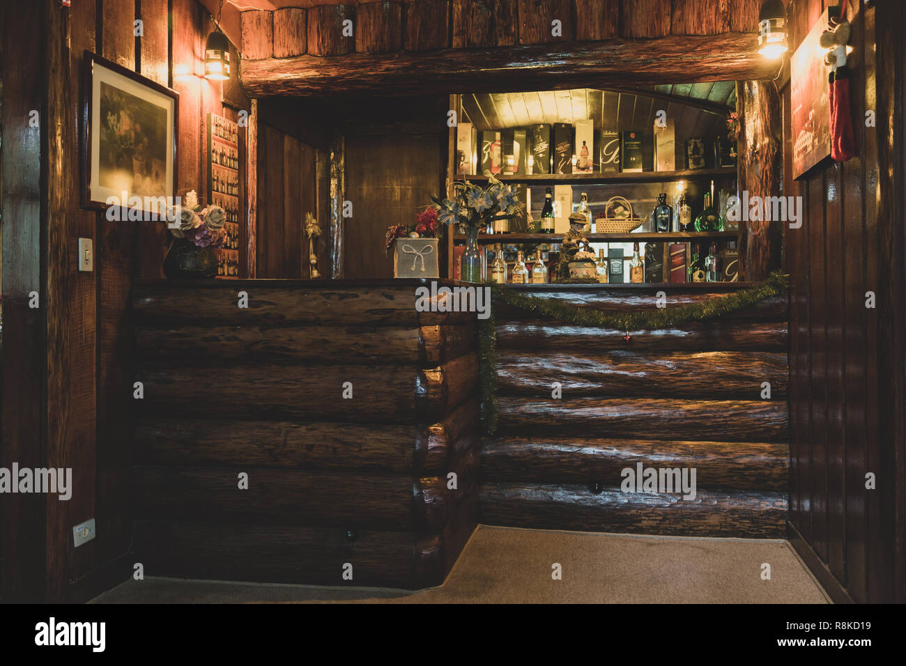 Authentic interiors, rustic country wooden bar counter with different drinks “spirits” at hotel, Campos do Jordao, state of Sao Paulo, Brazil Stock Photo