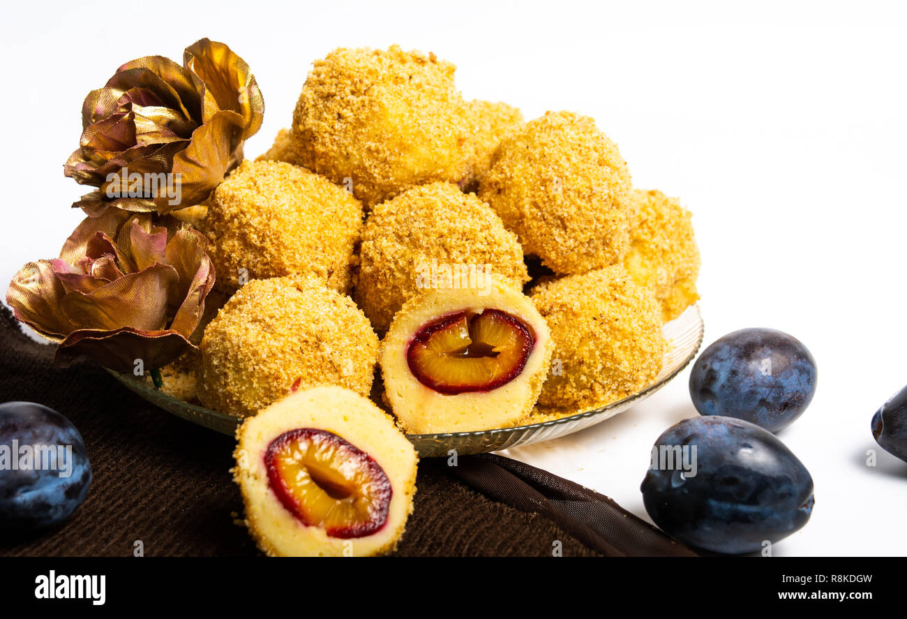 Bread crumb dumplings with plums on a plate isolated Stock Photo