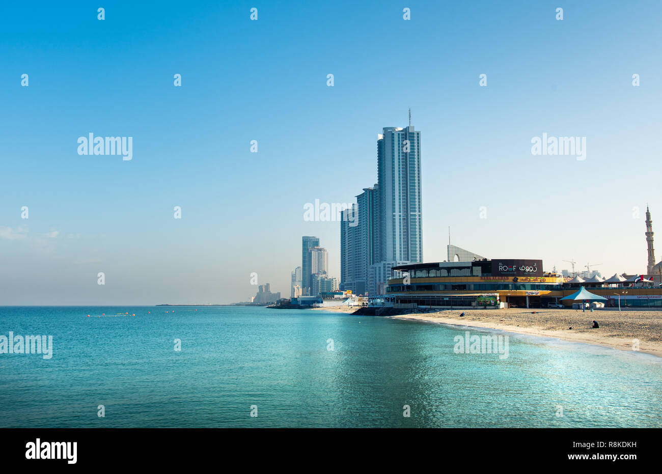 Ajman, United Arab Emirates - December 6, 2018: Ajman Corniche Beach beautiful coast in the city downtown area surrounded by high residential building Stock Photo