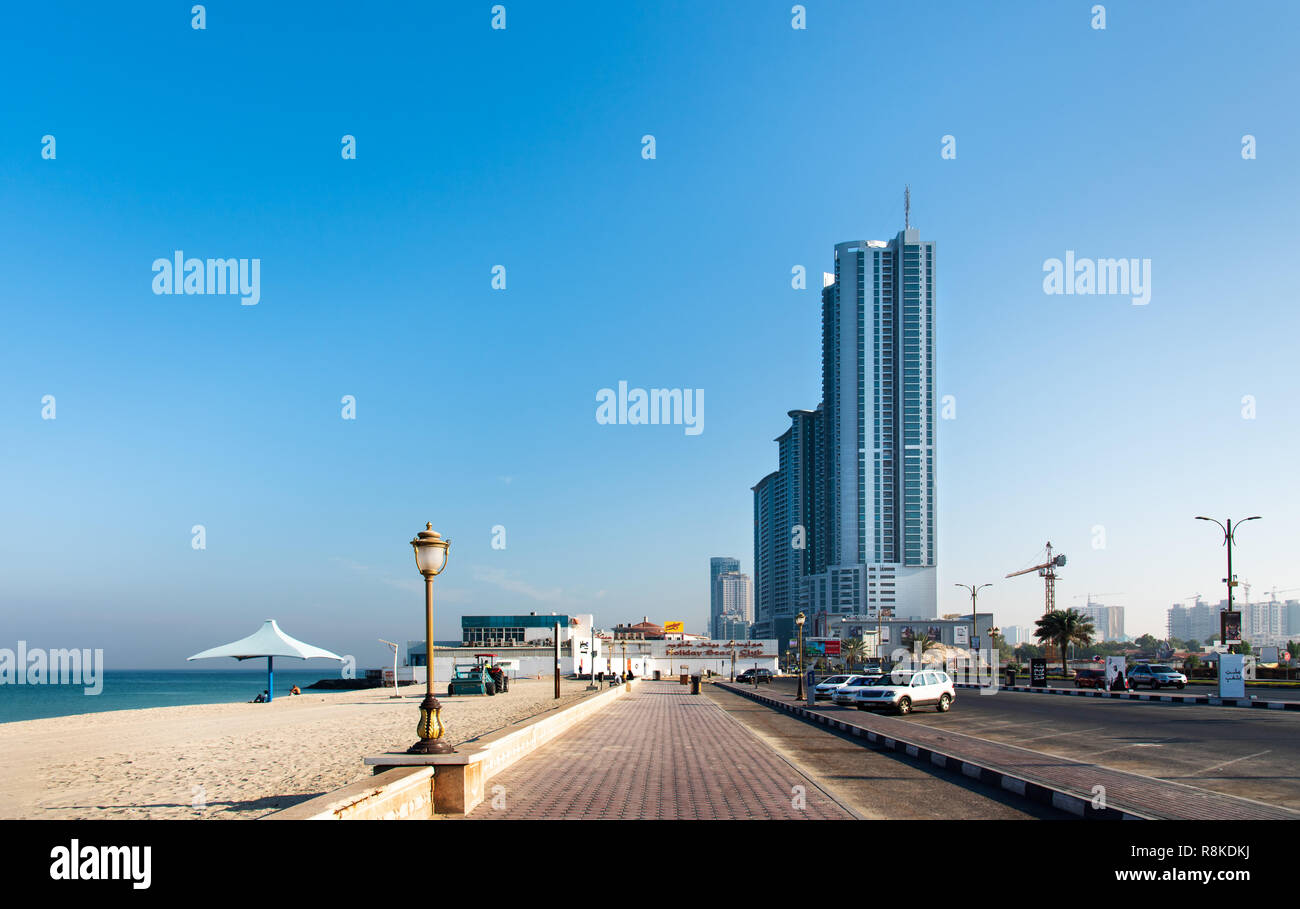 Ajman, United Arab Emirates - December 6, 2018: Ajman Corniche Beach beautiful coast in the city downtown area surrounded by high residential building Stock Photo