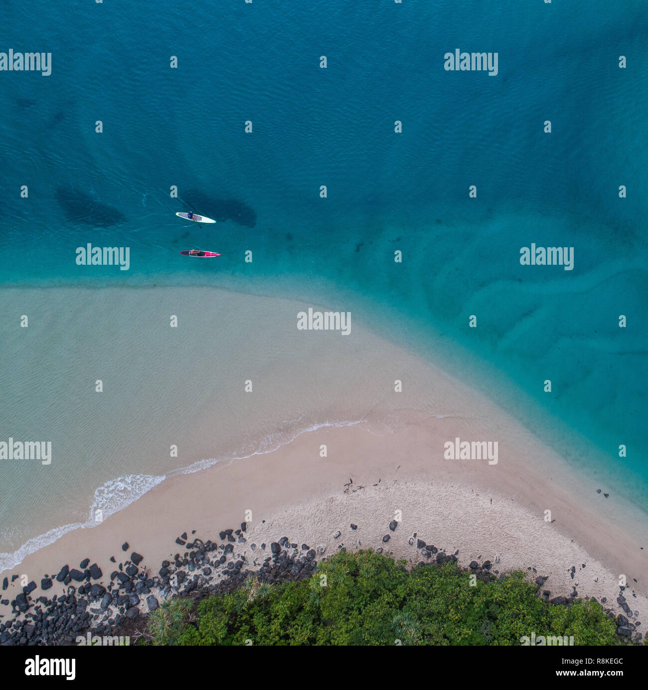 Kayak aerial in the blue creek. Beautiful drone shot of a man kayaking in shallow water perfect for fishing, sport and fitness active. Stock Photo
