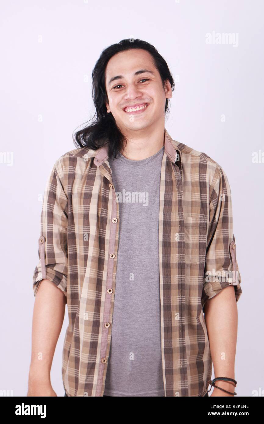 Photo image portrait of a cute young successful Asian male student with long hair, in relaxed standing position, half body portrait Stock Photo