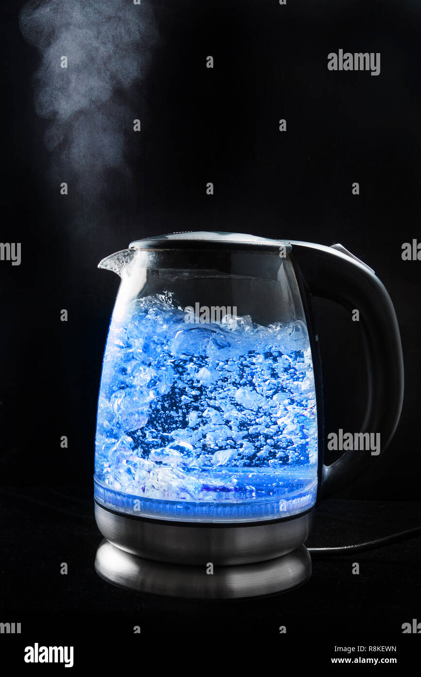 https://c8.alamy.com/comp/R8KEWN/boiling-glass-kettle-with-blue-light-on-a-black-background-steam-comes-from-the-spout-R8KEWN.jpg
