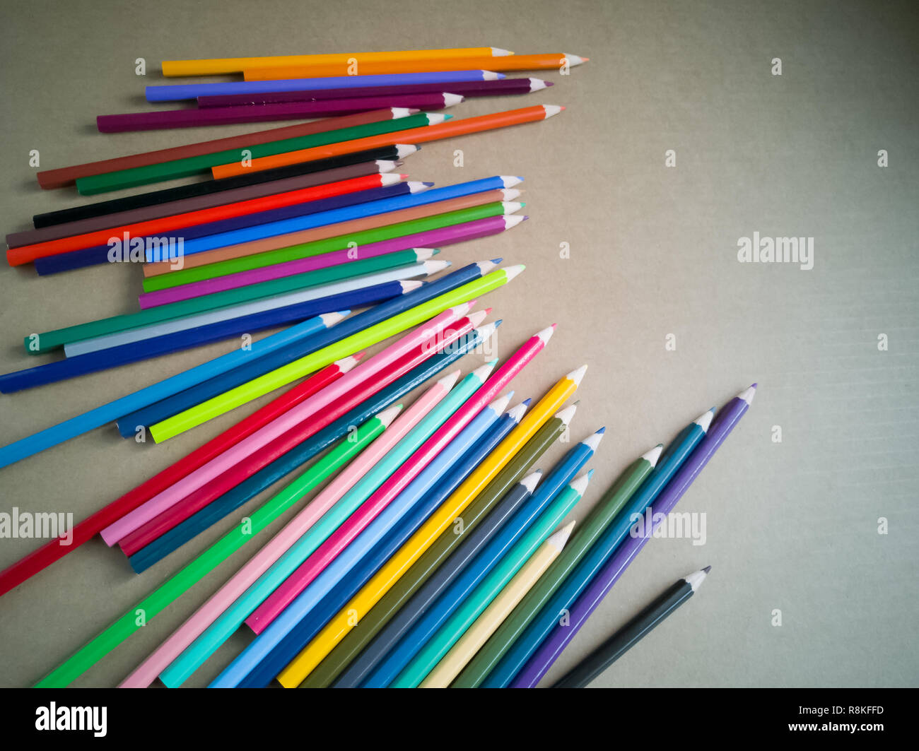 Colour pencils isolated on brown wooden clean background. Close up. Stock Photo