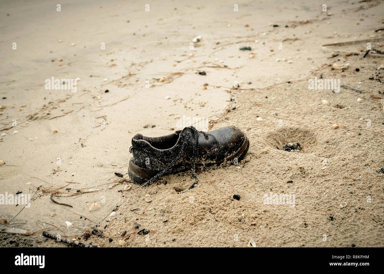 shoes garbage the beach / sea water pollution with old shoes on sand in ...
