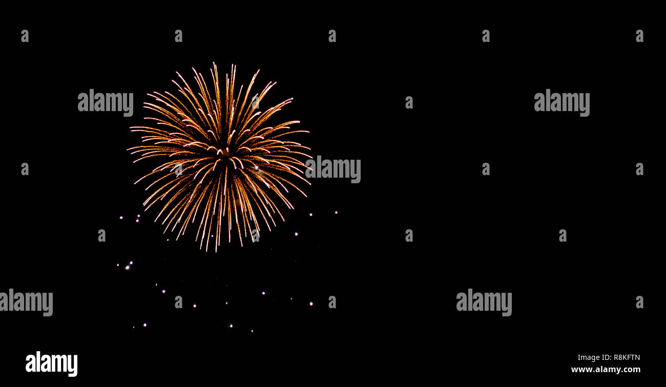 Glod and yellow fireworks on night sky with black backgrounds. Stock Photo