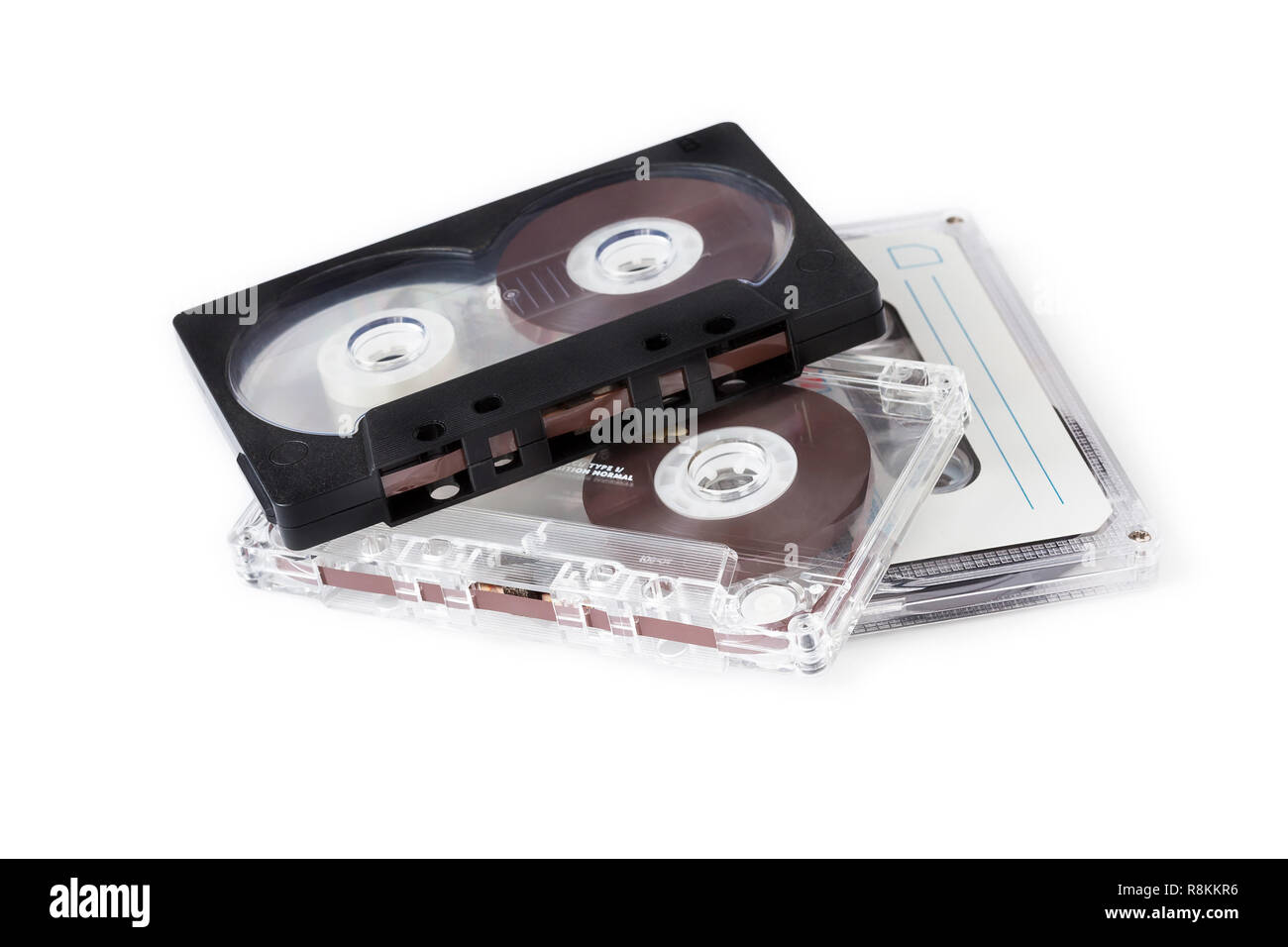 Three compact cassettes on white background.Retro. Stock Photo