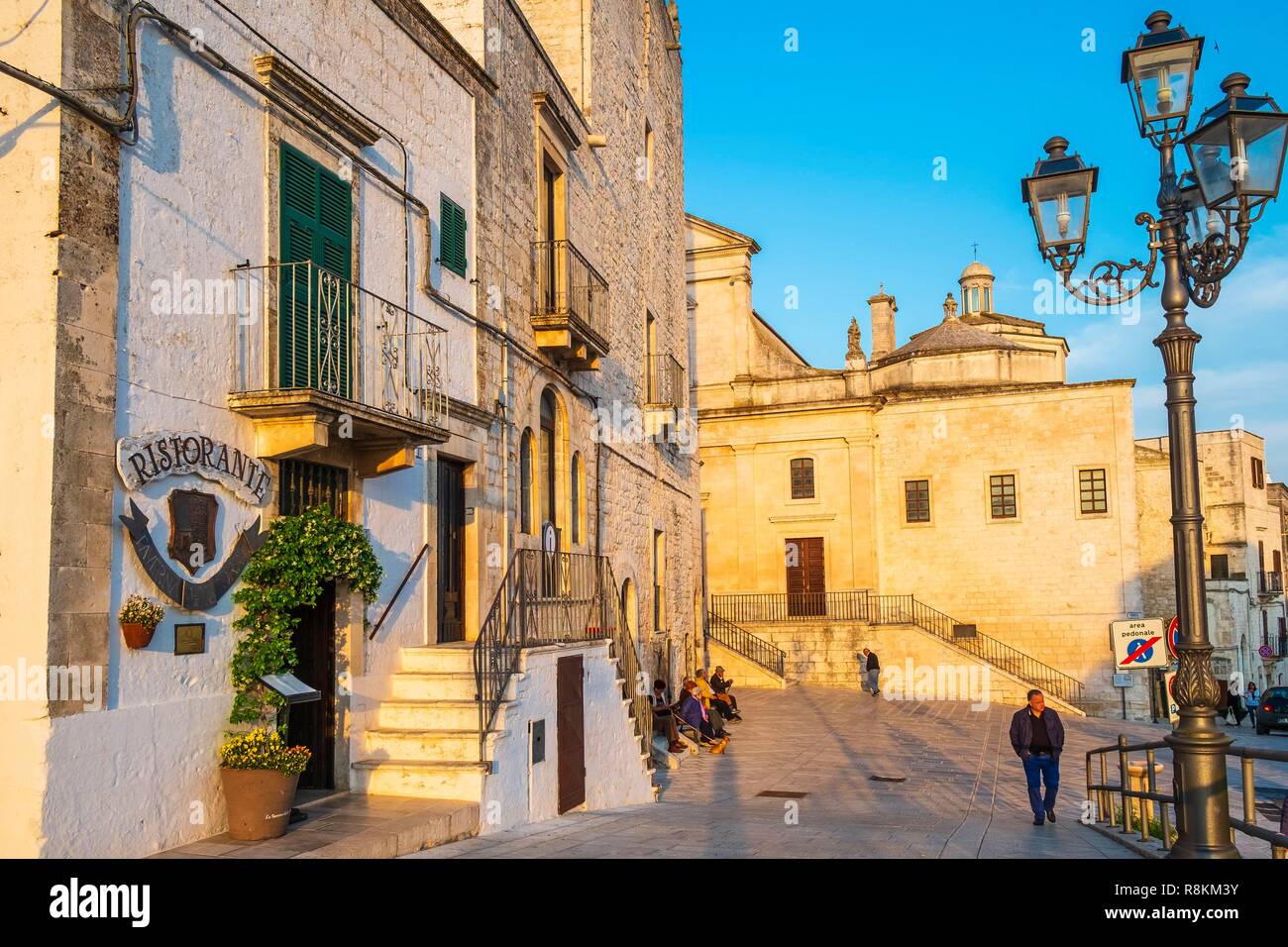 Italy, Apulia, Itria Valley, Cisternino, Piazza Giuseppe Garibaldi, Mother Church, devoted to St Nicholas from Patara (St Nicholas of Bari) was built in Apulian late romanesque style around the XV century and the Norman-Swabian tower or Porta Grande on the left Stock Photo