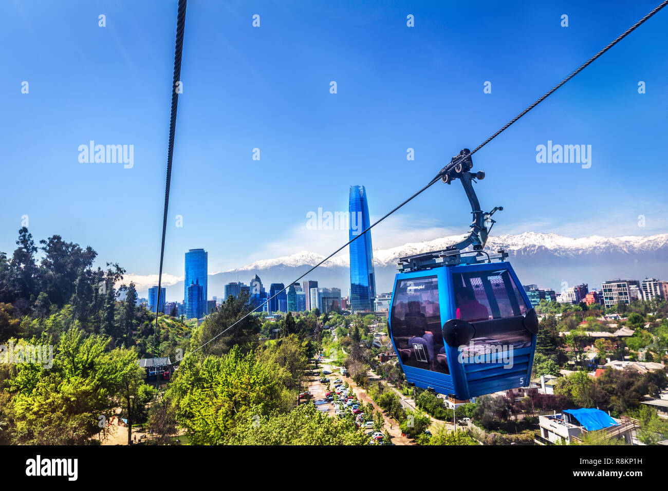 Santiago, Chile - Oct 15th 2017 - The city of Santiago del Chile seen from inside the cable car with the ICC buildings and the Andes with snow in the  Stock Photo