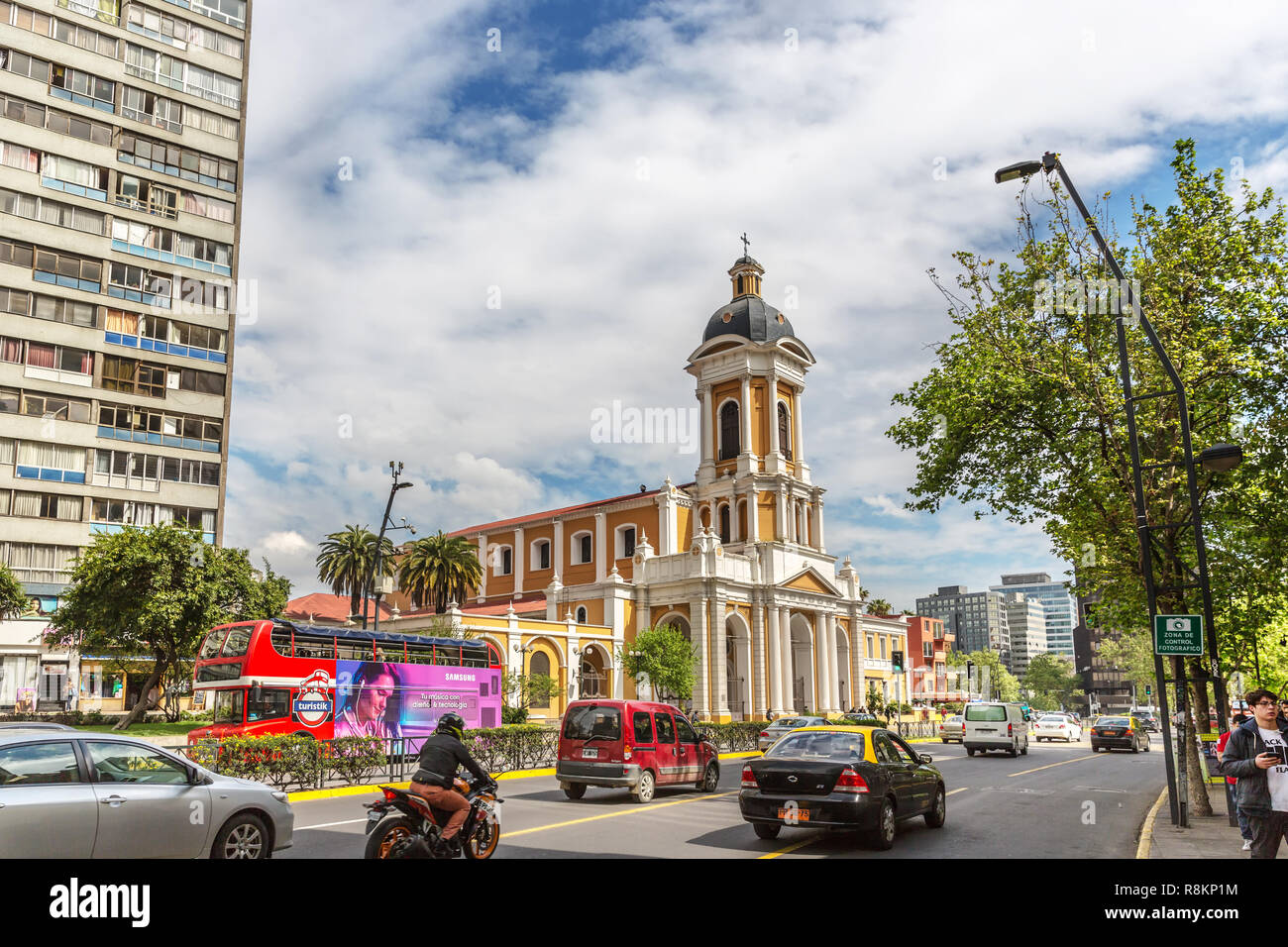 Santiago, Chile - Oct 15th 2017 - Cars and buses passing in a wide avenue with a catholic church in downtown Santiago del Chile, the capital of Chile Stock Photo