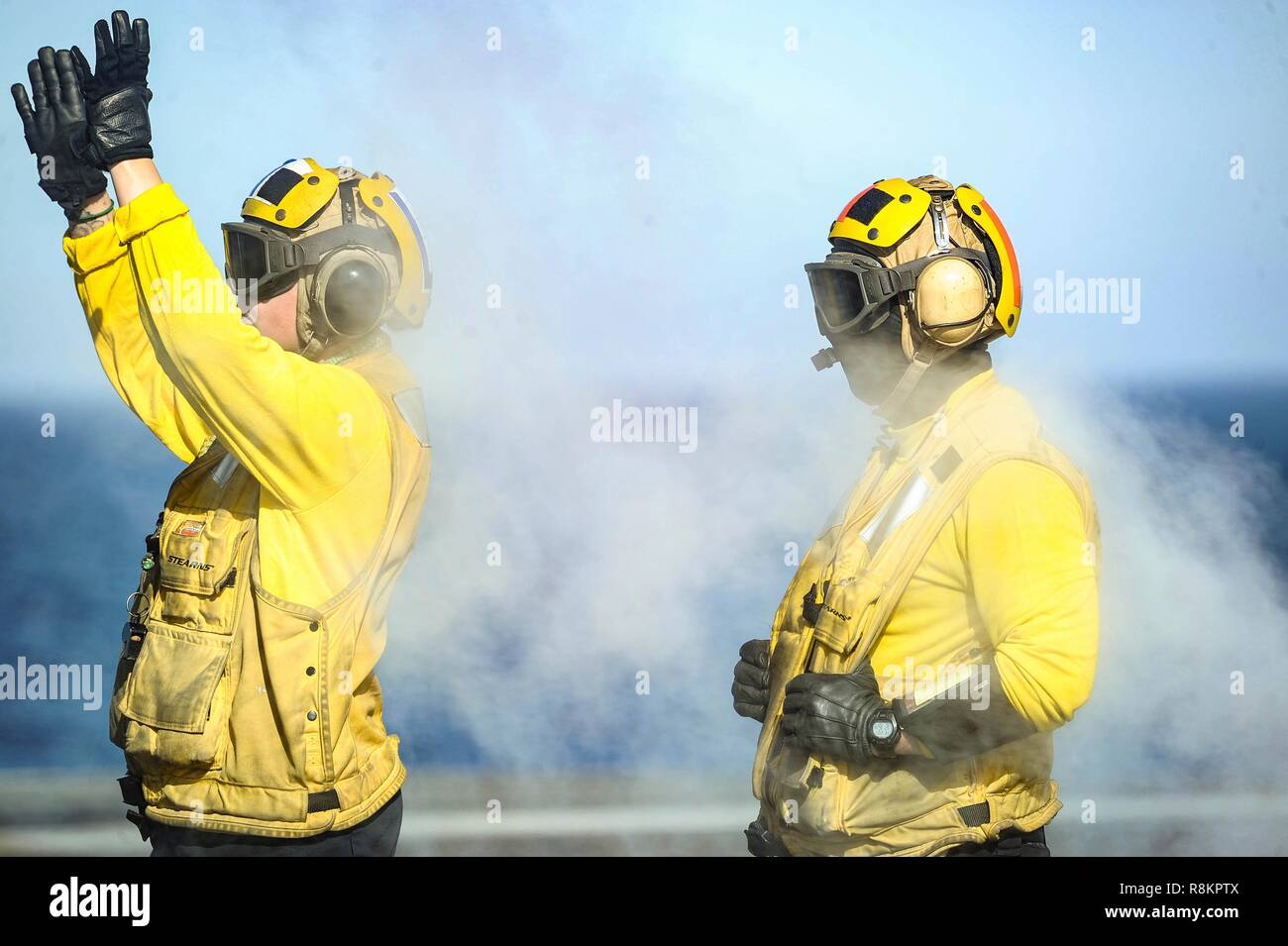 Flight directors known a yellow shirts coordinate flight deck operations aboard the Nimitz-class aircraft carrier USS Harry S. Truman December 7, 2018 in the Atlantic Ocean. Yellow shirts are worn by aircraft handlers, aircraft directors, Catapult Officers and Arresting Gear Officers considered the most difficult and important job on the flight deck. Stock Photo