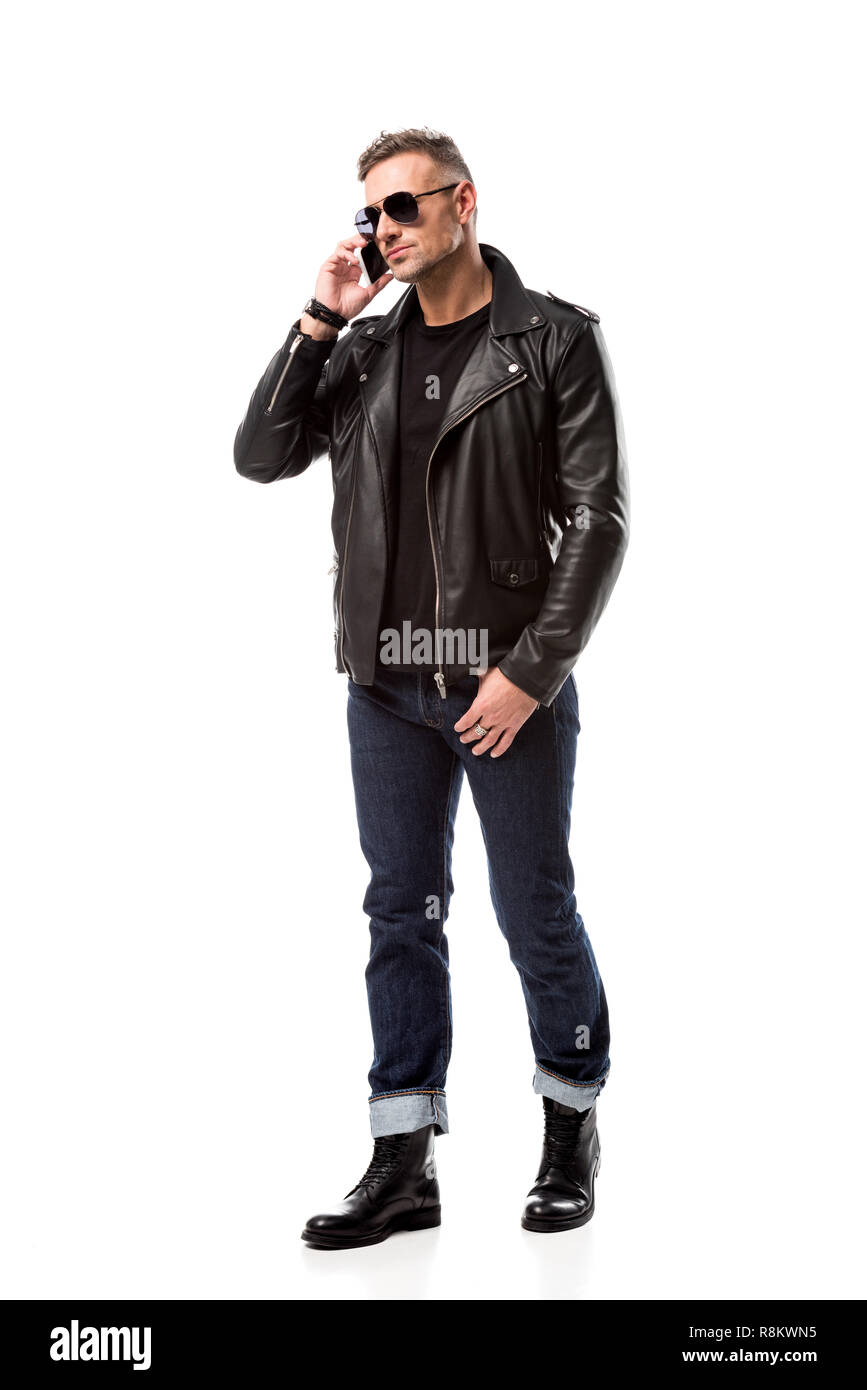 serious handsome man in sunglasses talking on smartphone isolated on